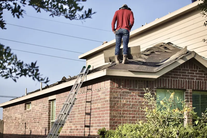 Professional roofer working on a residential roof in Pocono